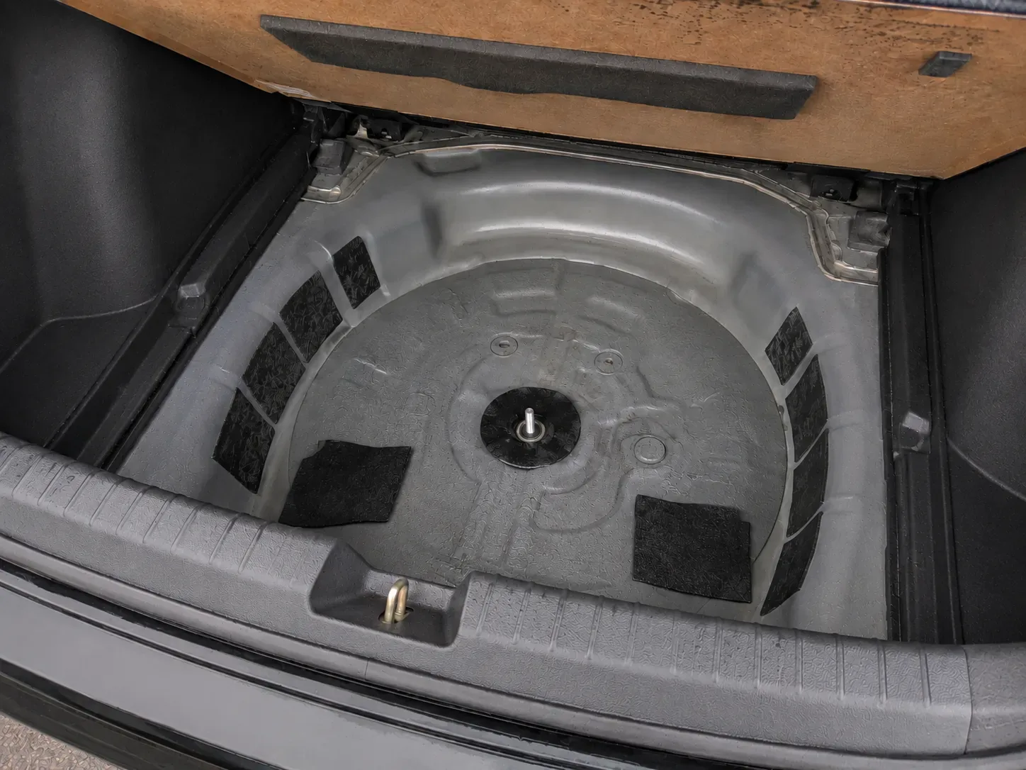 Standing water in a vehicle spare tire well